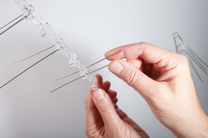 Bird deterrent spike section with thin metal rods mounted on transparent plastic base. Designed to prevent perching on royalty free stock photo