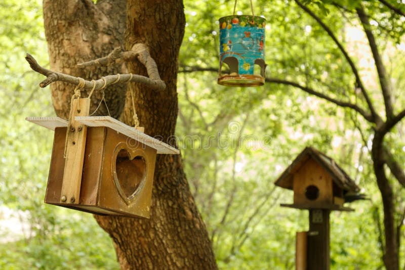 A birdhouse in the park. Homemade bird feeder. A birdhouse in the park. A homemade bird feeder in the forest stock photos A birdhouse in the park. Homemade bird feeder. A birdhouse in the park. A homemade bird feeder in the forest stock photos
