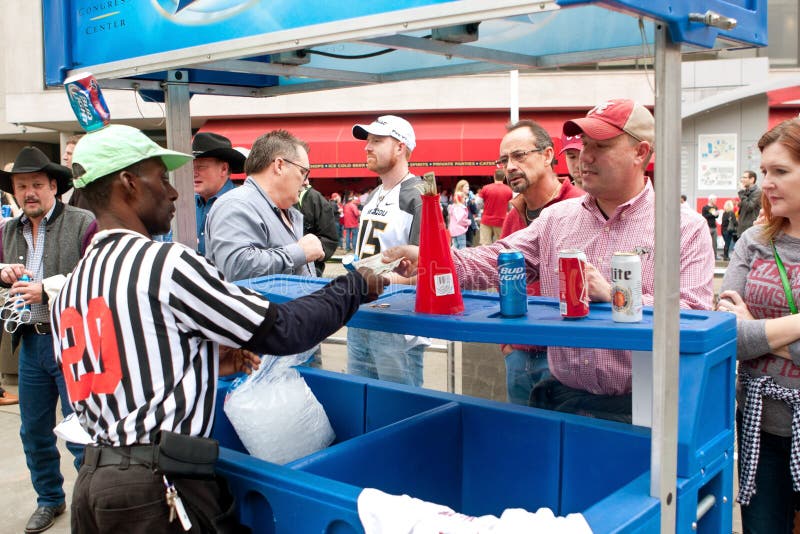 Atlanta, GA, USA - December 6, 2014: People buy beer from a beer vendor outside the Georgia Dome before the SEC Championship game. Atlanta, GA, USA - December 6, 2014: People buy beer from a beer vendor outside the Georgia Dome before the SEC Championship game.