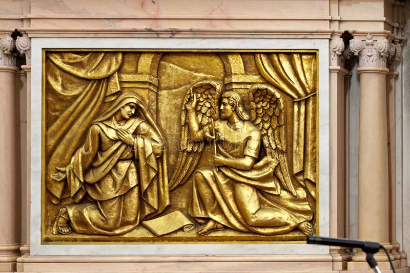 Bas-relief of the Basilica of Fatima representing one of the fourteen mysteries of the rosary (similar to the stations of the cross). This panel represents the Annunciation to Mary by the Angel (celebrated before Christmas). Bas-relief of the Basilica of Fatima representing one of the fourteen mysteries of the rosary (similar to the stations of the cross). This panel represents the Annunciation to Mary by the Angel (celebrated before Christmas).