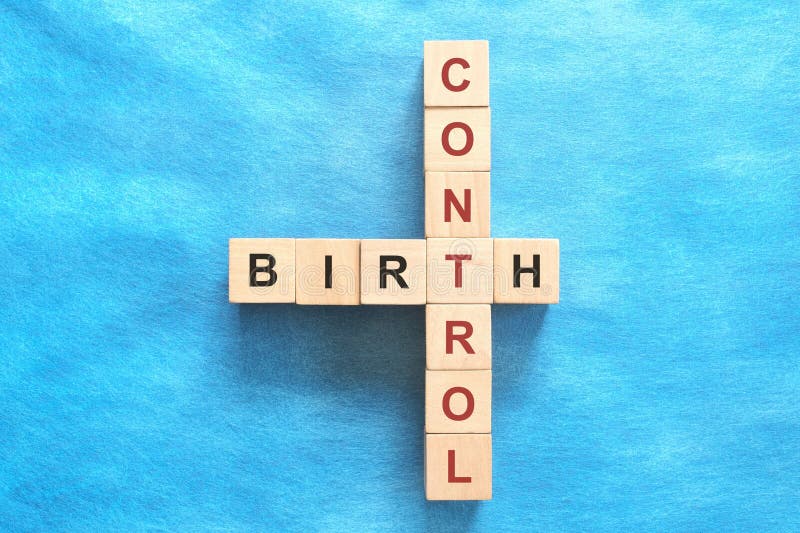 Birth Control Concept Crossword Puzzle Flat Lay in Blue Background Birth Control Concept Crossword Puzzle Flat Lay in Blue Background