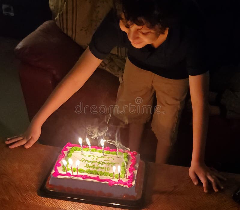 Birthday Boy Blowing Out Candles Stock Image Image of candles