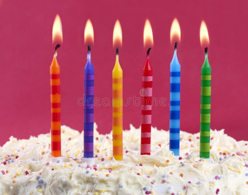 Birthday cake with candles. Birthday cake with 6 coloured candles on a red background stock images Birthday cake with candles. Birthday cake with 6 coloured candles on a red background stock images