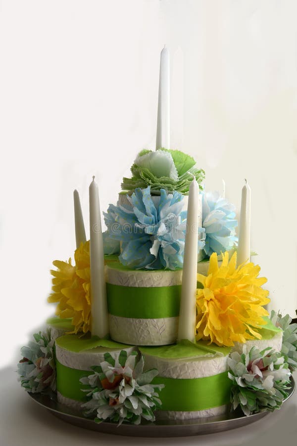 Birthday cake made of toilet paper. Rolls decorated with flowers of paper handkerchiefs and candles standing on a table royalty free stock photography Birthday cake made of toilet paper. Rolls decorated with flowers of paper handkerchiefs and candles standing on a table royalty free stock photography