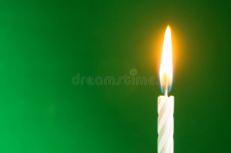 The birthday candle on a green background