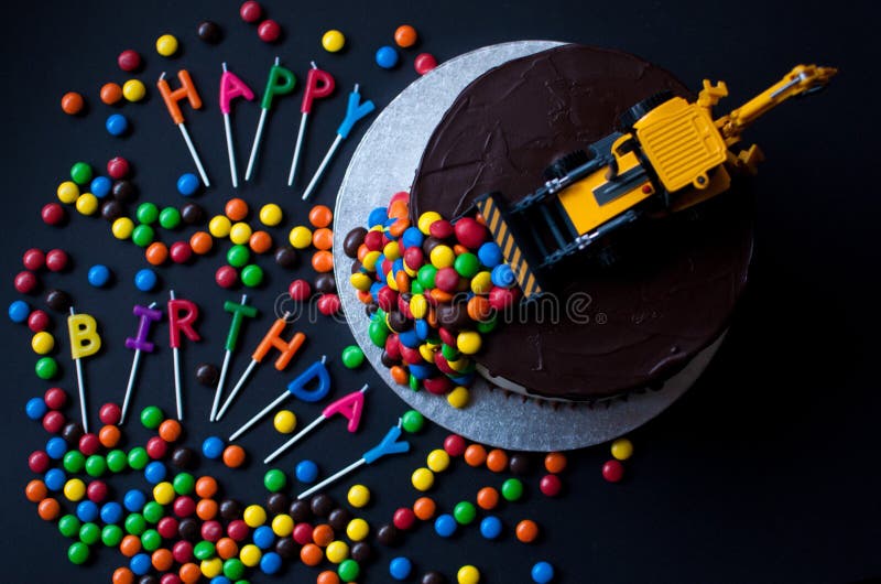 Birthday Chocolate Cake with Tractor and Candy on Top. Stock Image