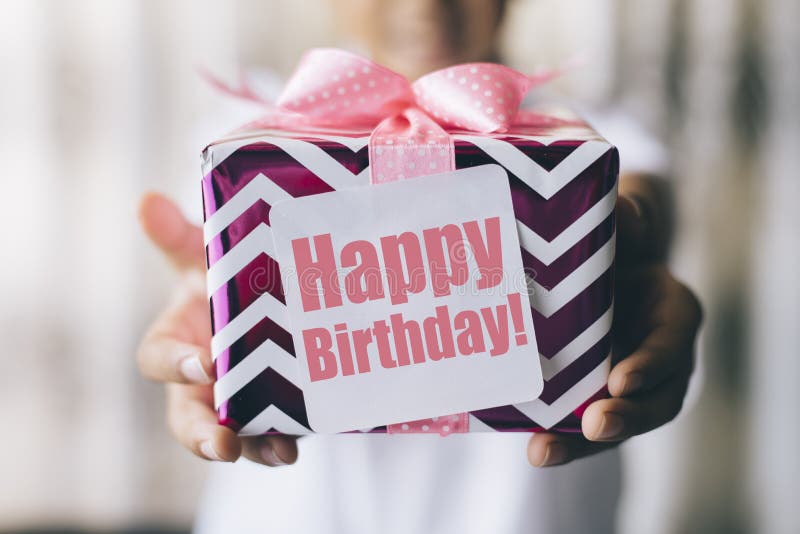 Birthday gift. Birthday concept - young boy holding decorated gift box / present with ` happy birthday ` note stock photos Birthday gift. Birthday concept - young boy holding decorated gift box / present with ` happy birthday ` note stock photos
