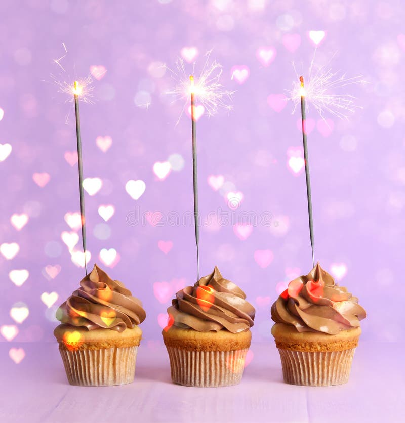 Birthday cupcakes with sparklers on background. Party decor royalty free stock photo Birthday cupcakes with sparklers on background. Party decor royalty free stock photo