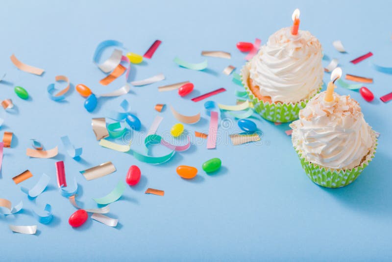 Birthday hat with confetti and cupcake on paper background stock photography Birthday hat with confetti and cupcake on paper background stock photography