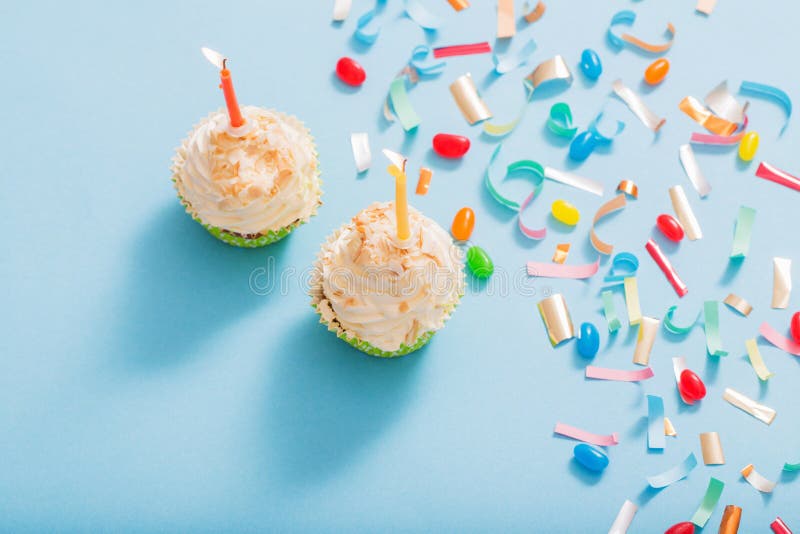 Birthday hat with confetti and cupcake on paper background stock photo Birthday hat with confetti and cupcake on paper background stock photo
