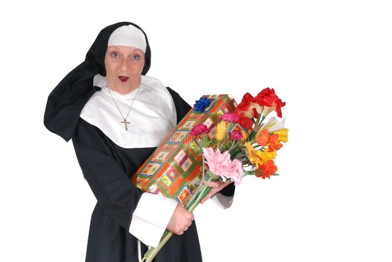 Middle aged sister, nun with birthday present and flowers. Religion, christianity, lifestyle, holiday concept. Middle aged sister, nun with birthday present and flowers. Religion, christianity, lifestyle, holiday concept