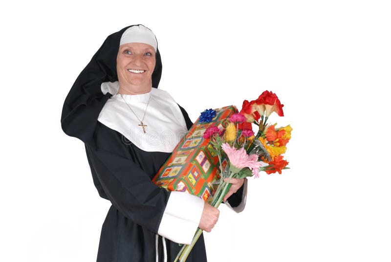 Middle aged sister, nun with birthday present and flowers. Happy expression on face, big smile. Middle aged sister, nun with birthday present and flowers. Happy expression on face, big smile