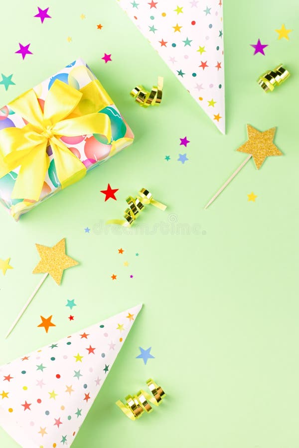 Birthday party background with wrapped gifts, confetti, party hats, decorations, top view royalty free stock photography Birthday party background with wrapped gifts, confetti, party hats, decorations, top view royalty free stock photography