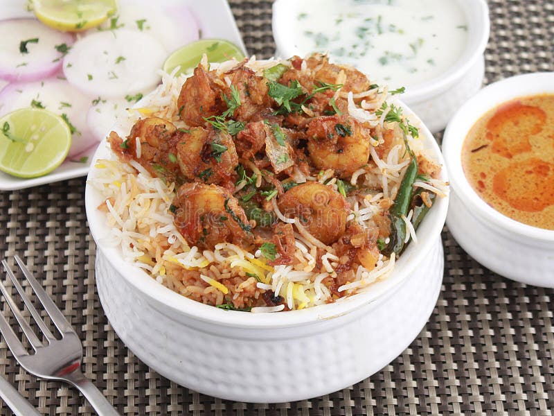 Biryani with a twist, made with prawns, served with korma. Biryani with a twist, made with prawns, served with korma