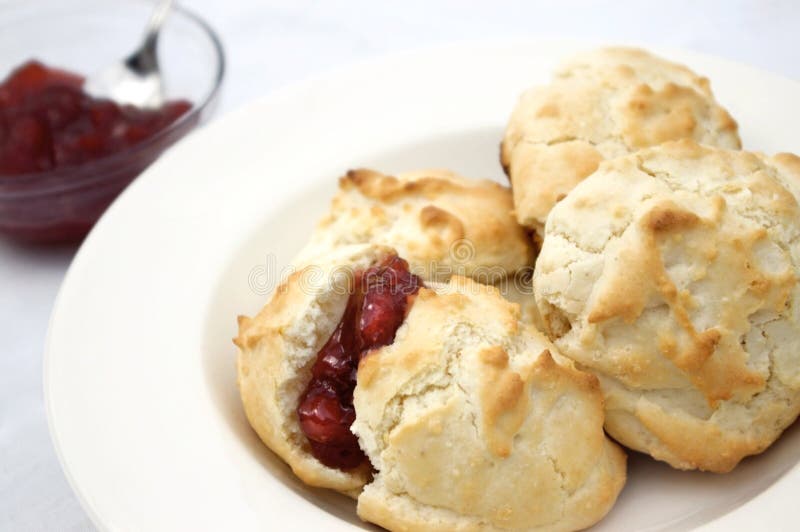 Fresh homemade buttermilk biscuits with strawberry preserves. Fresh homemade buttermilk biscuits with strawberry preserves.