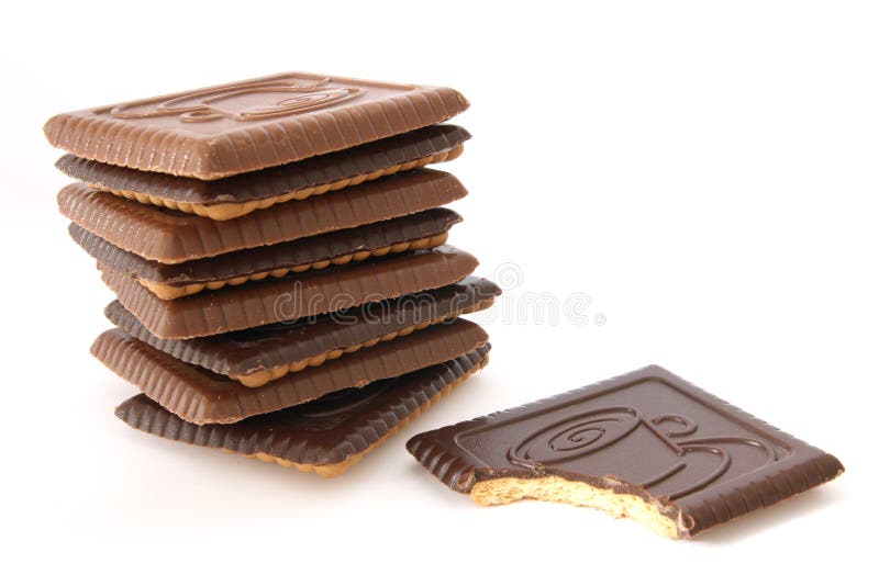 Stack of butte biscuits covered with milk and dark chocolate, one partially bitten. Stack of butte biscuits covered with milk and dark chocolate, one partially bitten