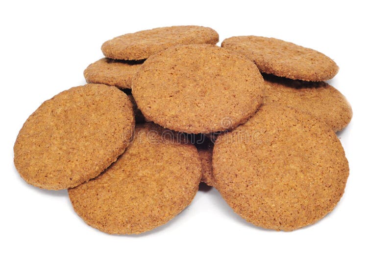 A pile of brown biscuits on a white background. A pile of brown biscuits on a white background