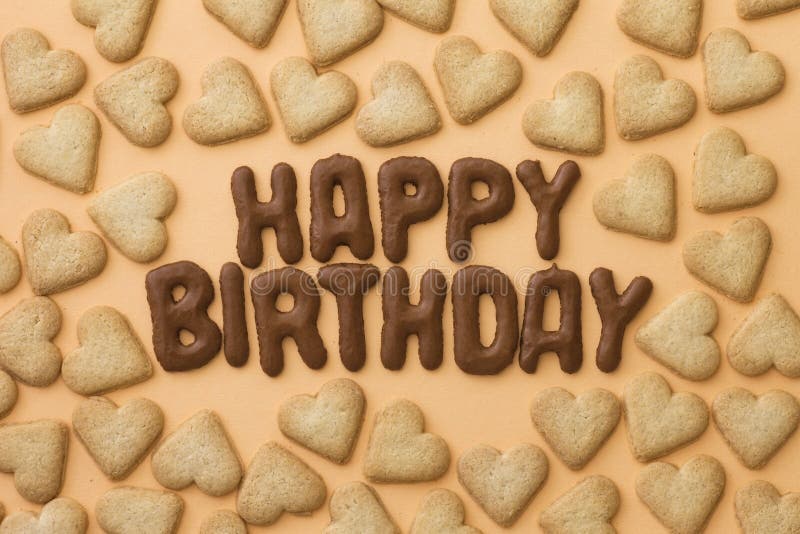 Happy Birthday written with Russian bread letter biscuits surrounded by heart-shaped cookies. Happy Birthday written with Russian bread letter biscuits surrounded by heart-shaped cookies