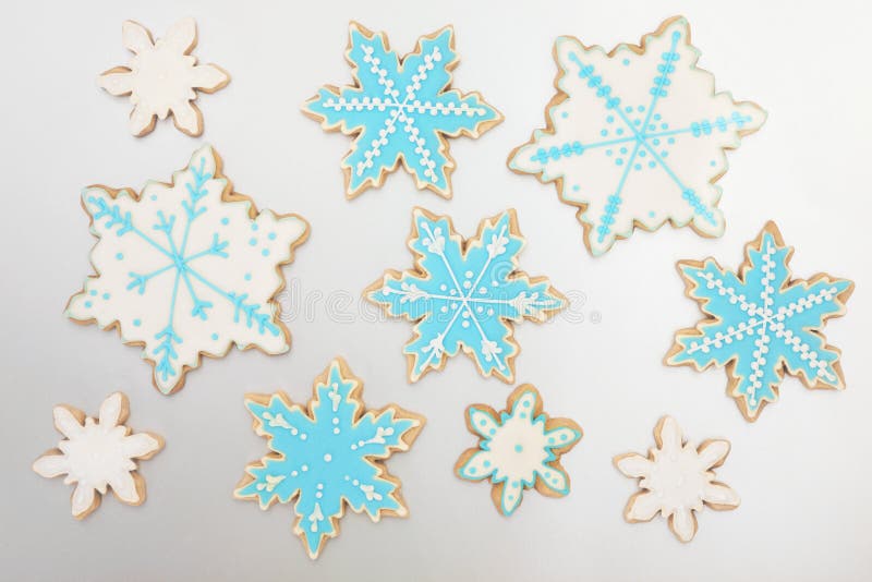 Christmas gingerbread snowflake biscuits over silver background. Christmas gingerbread snowflake biscuits over silver background.