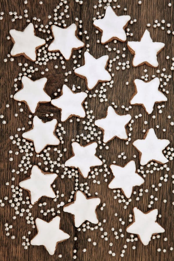 Christmas star gingerbread biscuits with silver balls over old oak wood background. Christmas star gingerbread biscuits with silver balls over old oak wood background