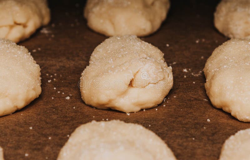 Shaped cookies with sugar sprinkles on a baking sheet. Shaped cookies with sugar sprinkles on a baking sheet.