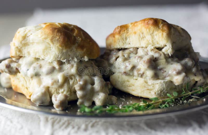 Biscuits and gravy on a silver plate. Southern style sausage gravy and buttermilk biscuits, close view. stock photography Biscuits and gravy on a silver plate. Southern style sausage gravy and buttermilk biscuits, close view. stock photography