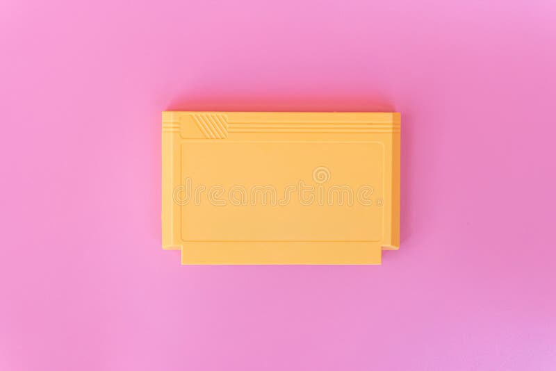 8 bit game cartridge for retro game console on pink background. Minimal concept