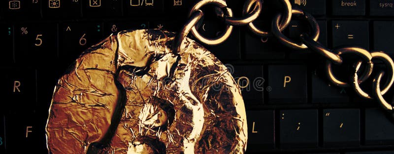 Bitcoin chain Header. Real coin of crypto currency joined by metal chain is on a computer keyboard royalty free stock images