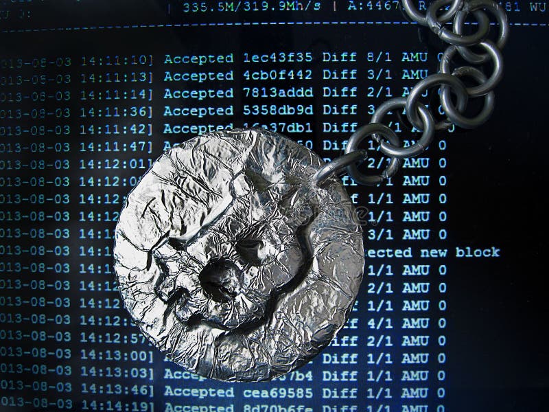Bitcoin chain. Real coin of crypto currency joined by metal chain is on a mining computer screen royalty free stock photo
