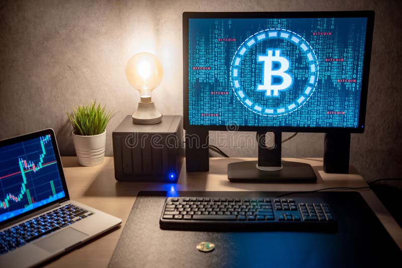 Bitcoin On Desk With Graphic And Candlestick Graph On Screen Stock