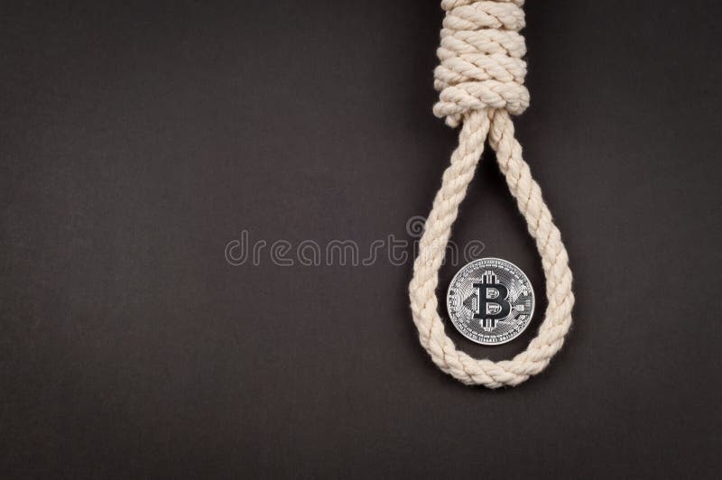 Falling bitcoin, the concept of a symbol of a coin in a loop of rope, financial death, problems with cryptocurrency, dark background. Falling bitcoin, the concept of a symbol of a coin in a loop of rope, financial death, problems with cryptocurrency, dark background