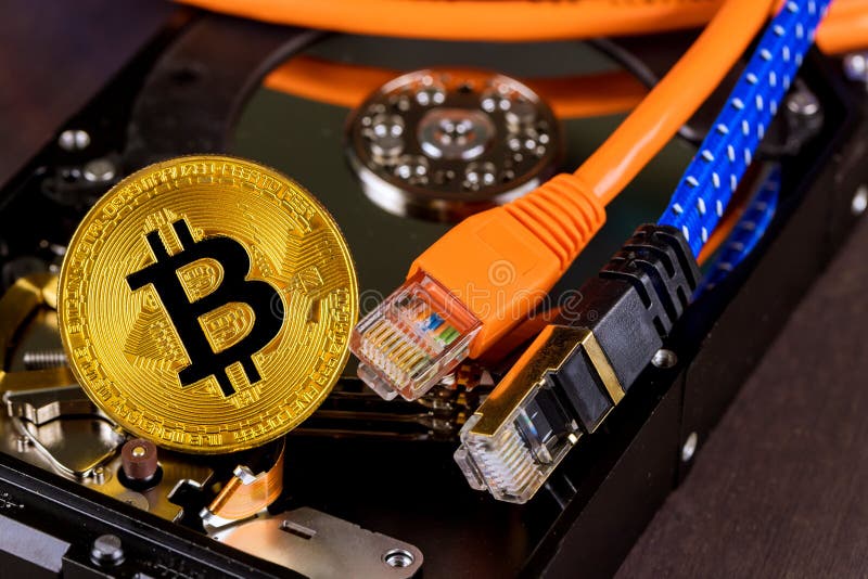 Bitcoin en or repose sur un disque dur connecté à la crypto-monnaie blockchain via les câbles ethernet photos stock