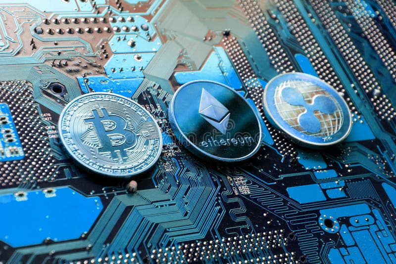 Bitcoin, Ethereum, Ripple coins on computer motherboard, cryptocurrency investing concept