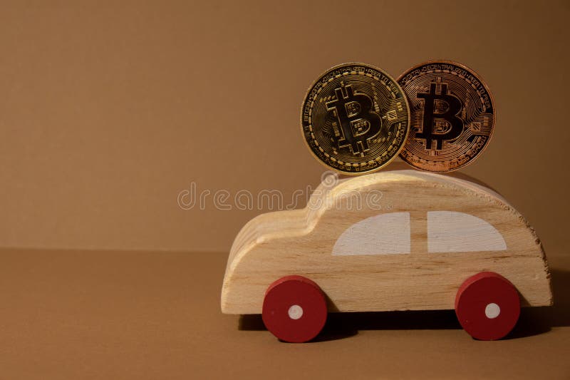 Bitcoin gold coin with wooden toy car. Saving and manage money for transport car loan mining trading concept. Automotive