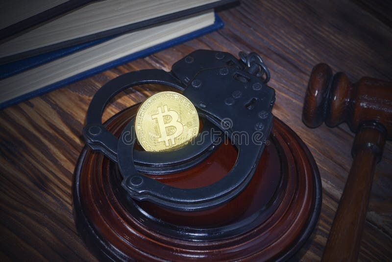 Bitcoin, judge`s hammer, handcuffs. Concept bitcoin ban, violation of the law