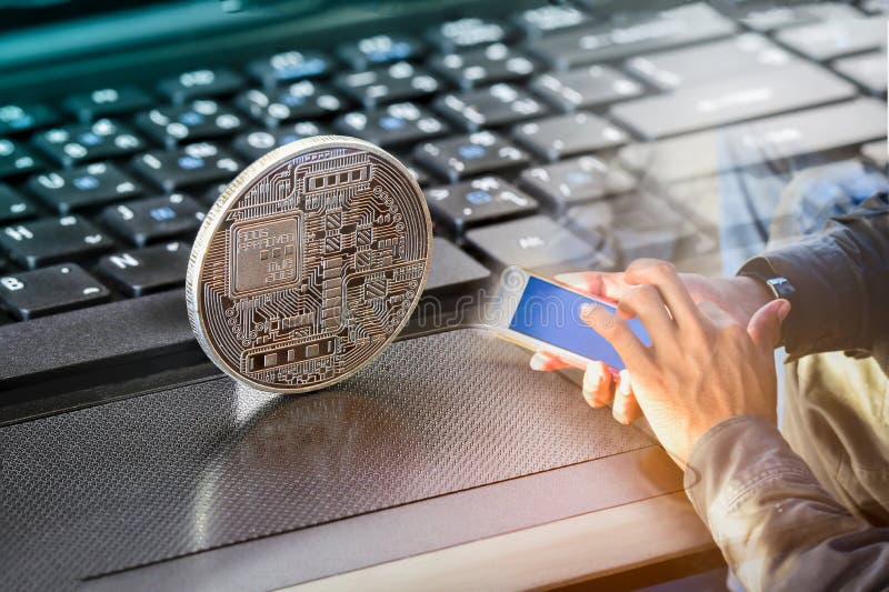 Golden bitcoin on a top of other coin and on the smart phone Double exposure Golden bitcoin on Note book and computer keyboard  new virtual money, shallow depth on field, hope that successful investment. Golden bitcoin on a top of other coin and on the smart phone Double exposure Golden bitcoin on Note book and computer keyboard  new virtual money, shallow depth on field, hope that successful investment.