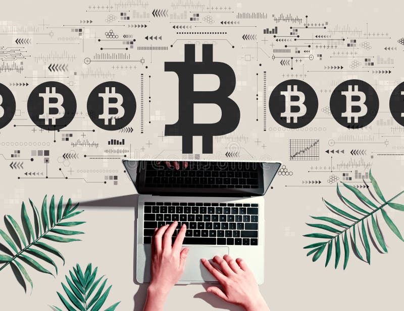 Bitcoin theme with person using a laptop royalty free stock image