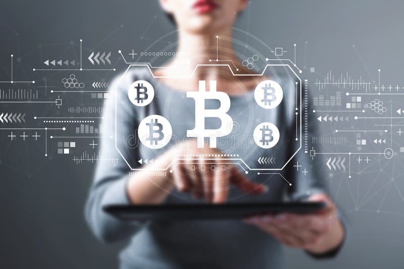 Bitcoin theme with woman using a tablet stock image