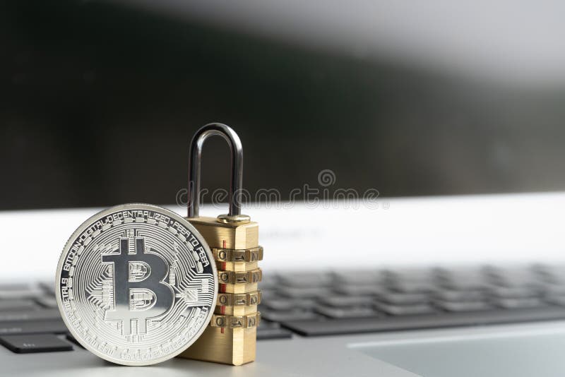 BitcoinBTC coin with padlock lying on computer background. stock images BitcoinBTC coin with padlock lying on computer background. stock images