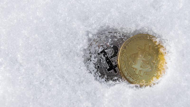 Bitcoins. Cryptocurrency on snow, in the background. The concept of freelancing, the stock exchange. Bitcoins on cold stock image