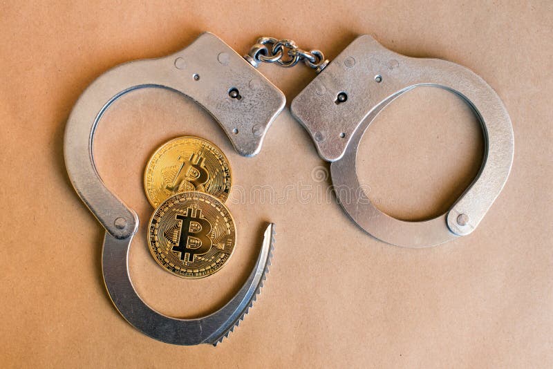 Bitcoins and handcuffs as an abstract symbol of crime that can h