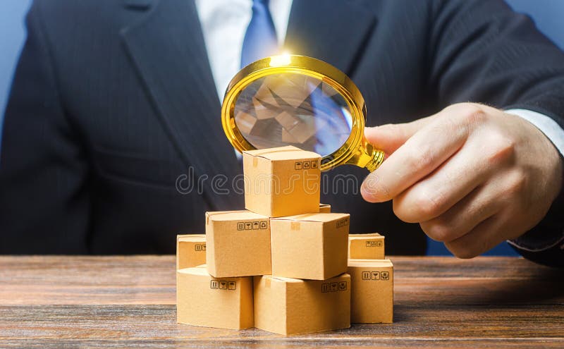 Businessman examines boxes goods with magnifying glass. Marketing sales promotion strategy. Trade market structure research, find unoccupied target consumer niches. Quality control and standards. Businessman examines boxes goods with magnifying glass. Marketing sales promotion strategy. Trade market structure research, find unoccupied target consumer niches. Quality control and standards