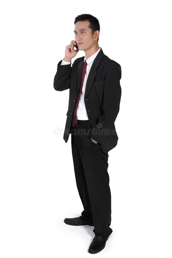 Biznesmen na telefonie, pozyci i przyglądającym up, obraz stock Biznesmen na telefonie, pozyci i przyglądającym up, obraz stock