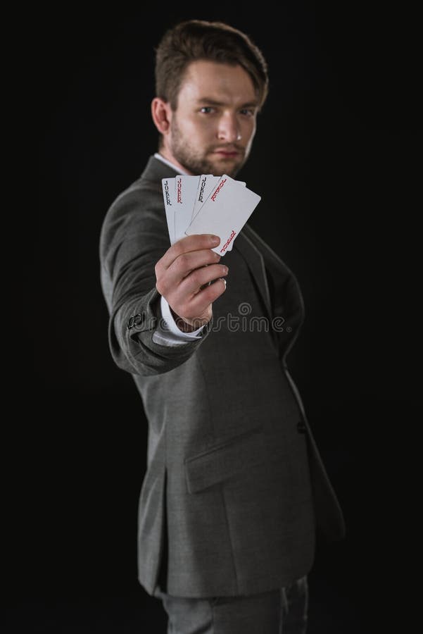 Biznesmen pokazuje joker karty odizolowywać na czerni obraz stock
