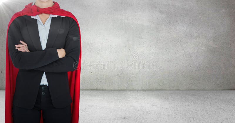 Digital composite of Business woman superhero with arms folded against grey wall with flare. Digital composite of Business woman superhero with arms folded against grey wall with flare