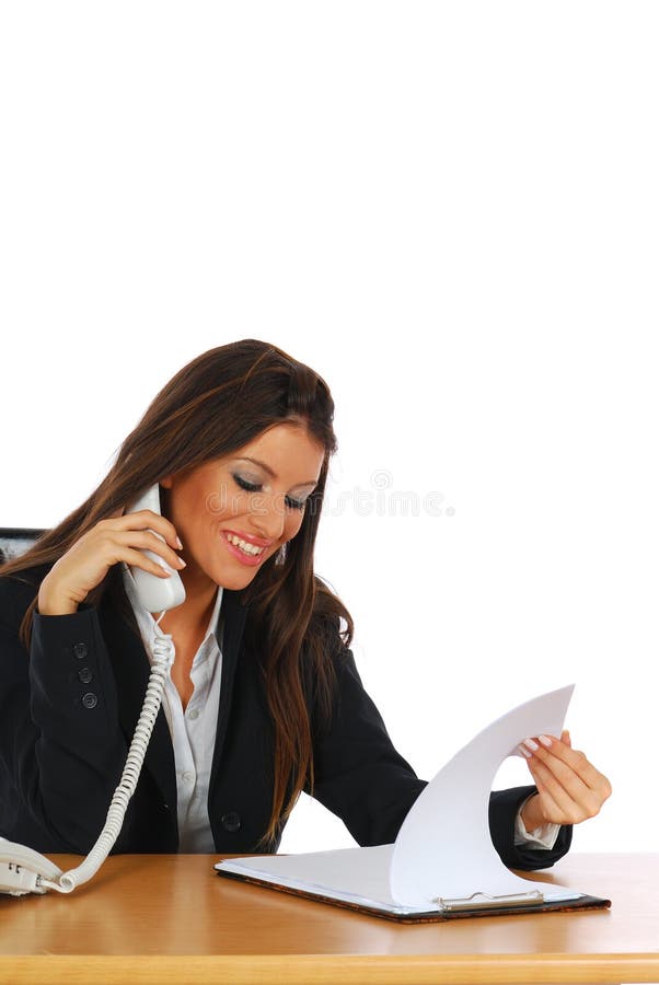 Attractive young businesswoman reviewing papers while talking on the phone with the customer, isolated on white. Attractive young businesswoman reviewing papers while talking on the phone with the customer, isolated on white