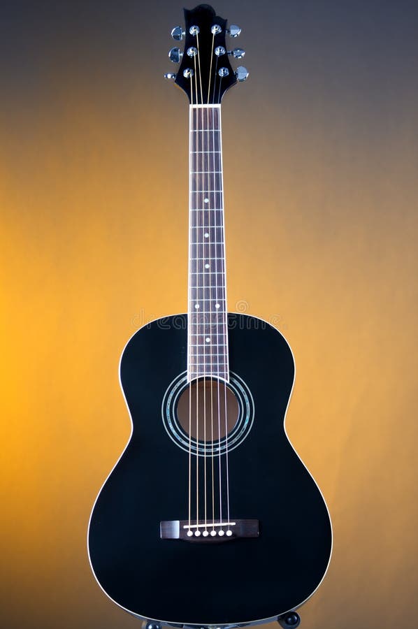 Black Acoustic Guitar On Yellow