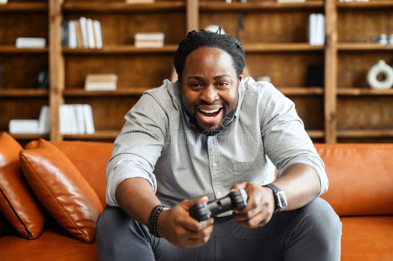 Person playing video games with controller on computer Stock Photo