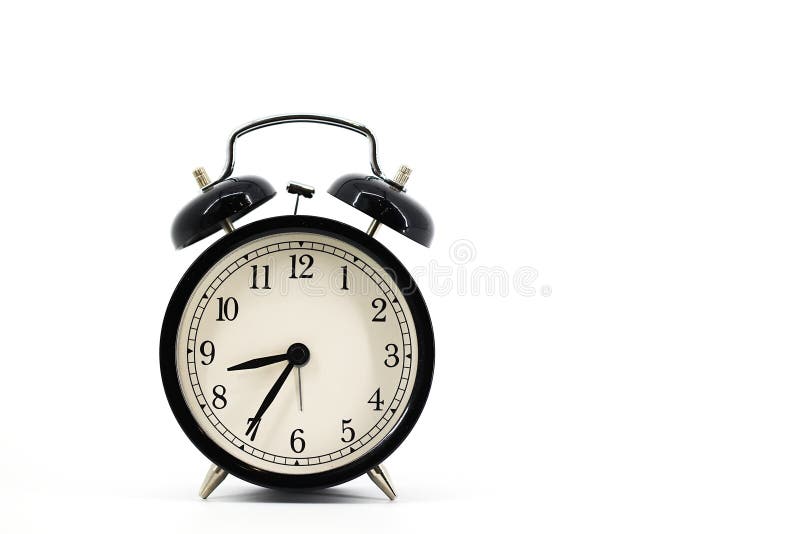 A black alarm clock with two bells on top, chrome handle, and legs, set against a white background. Timeless design meets royalty free stock photos