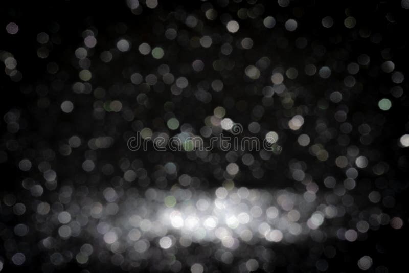 Black background for christmas navy glitter sparkle. Abstract bokeh light shiny dark holiday.